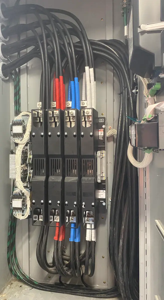 Commercial automatic transfer switch terminated with parallel phase-taped feeders